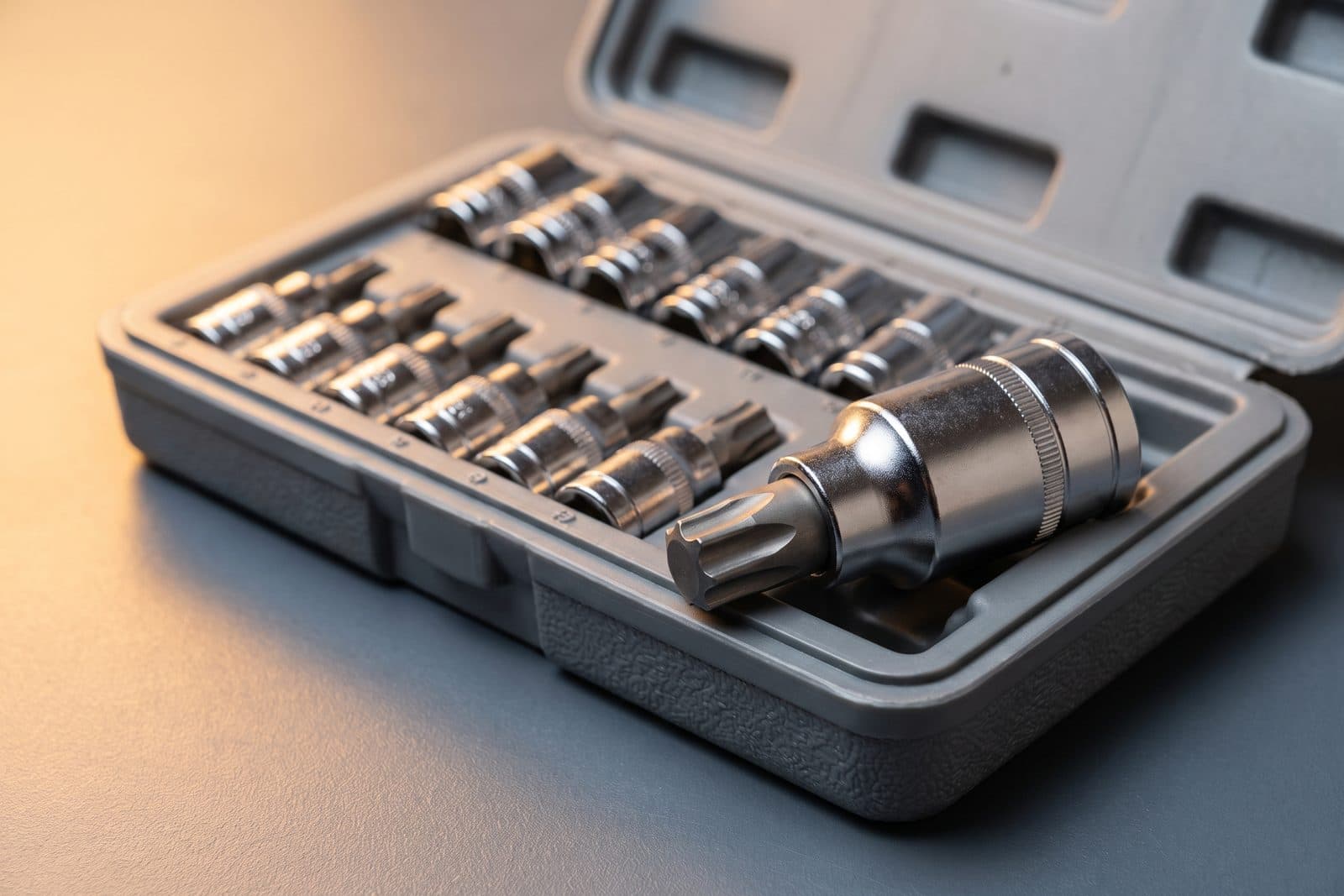 Torx bit socket set from T8 to T70 in an open case with one star bit held up close