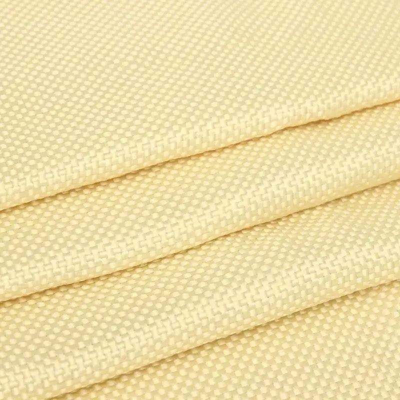 Aramid Fiber Cloth, folded multiple times, light yellow woven texture on plain background.