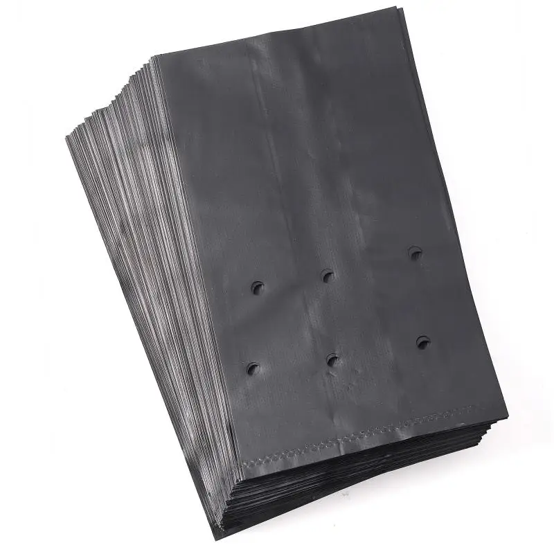 Grow bags: stack of black plastic bags with drainage holes on white background.