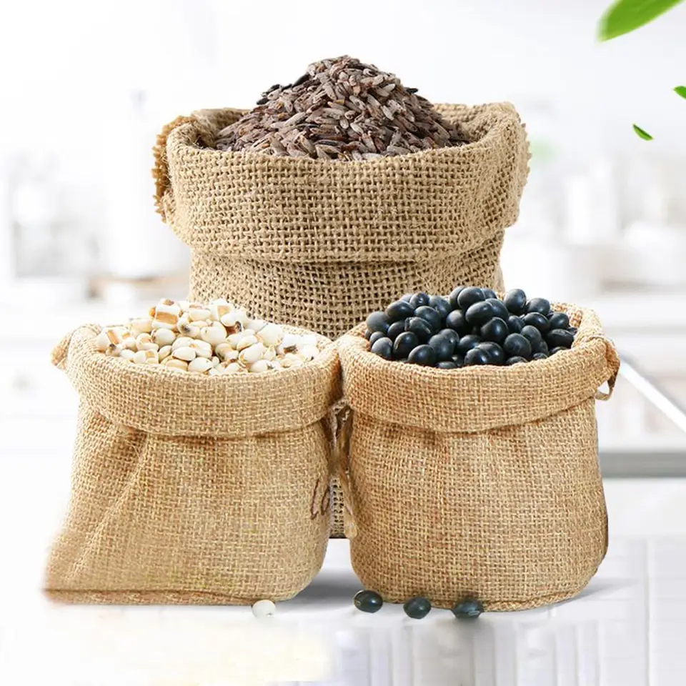 Screwfix Rubble Sack Jute: Three burlap sacks filled with grains, some spilled, on a light background.