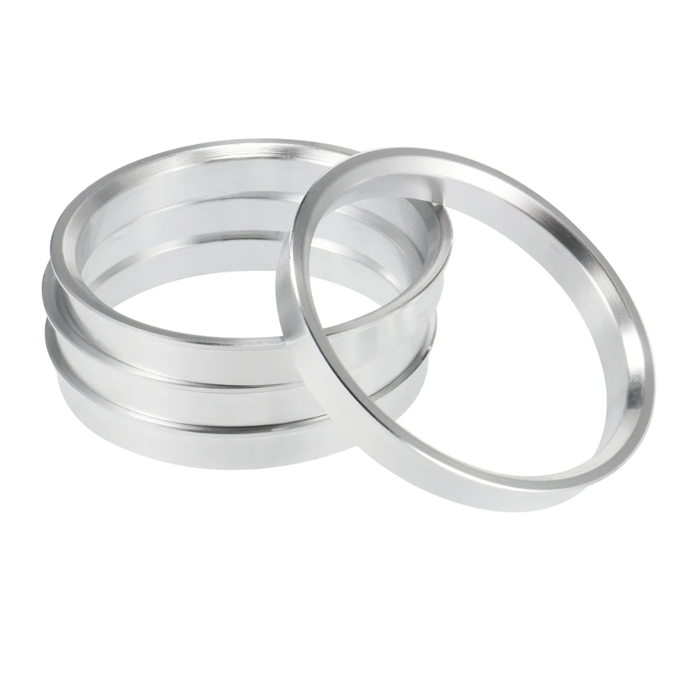 Four aluminum alloy car hub centric rings, serving as wheel spacers for various wheel bore center sizes.