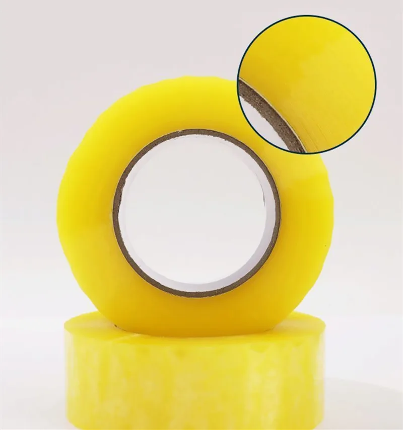 Clear packing tape, two rolls on a light background, magnified texture inset.