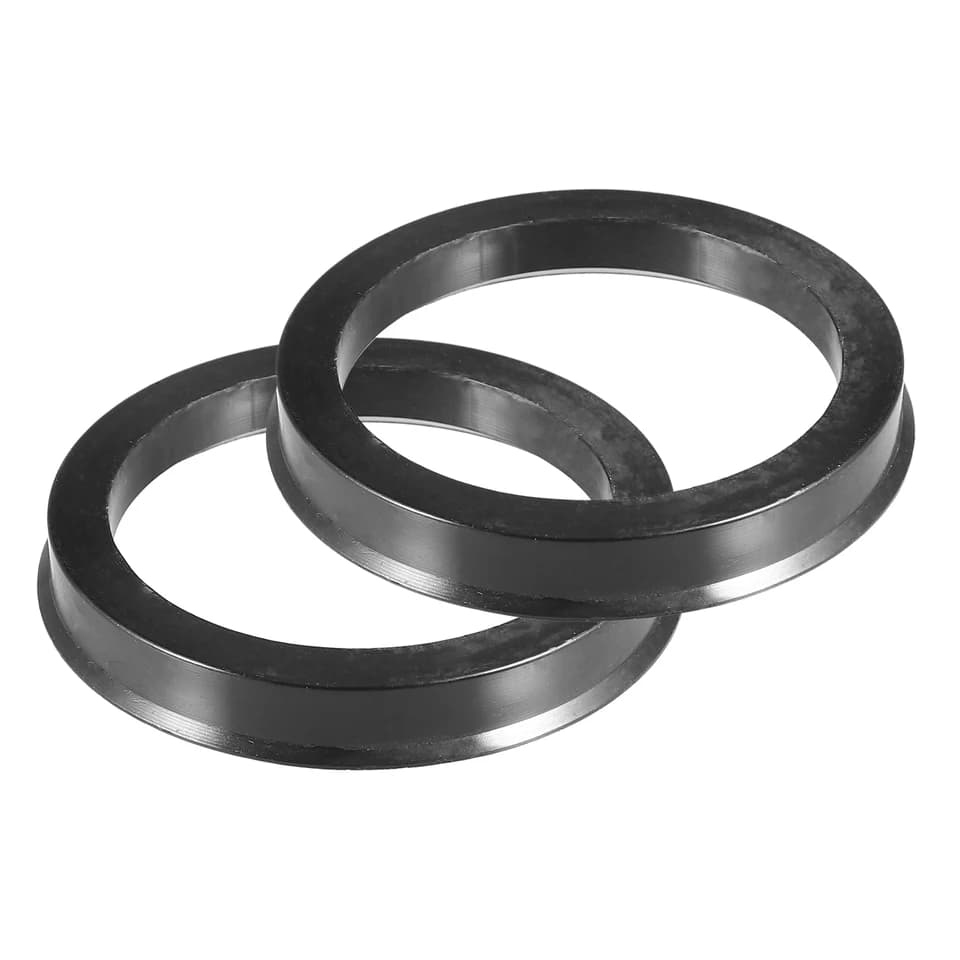 A set of four plastic car wheel hub centric rings, essential components like wheel spacers.