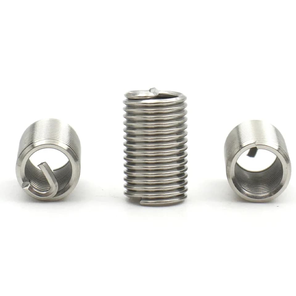 M1.6-M24 304 Stainless Steel Threaded Inserts: Three ground screw inserts on white.