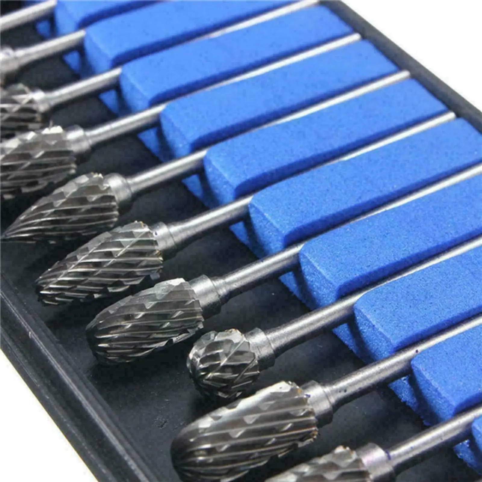 10-piece tungsten carbide rotary burr set with 1/8 inch shank for woodworking, engraving, and DIY projects on a dark background.