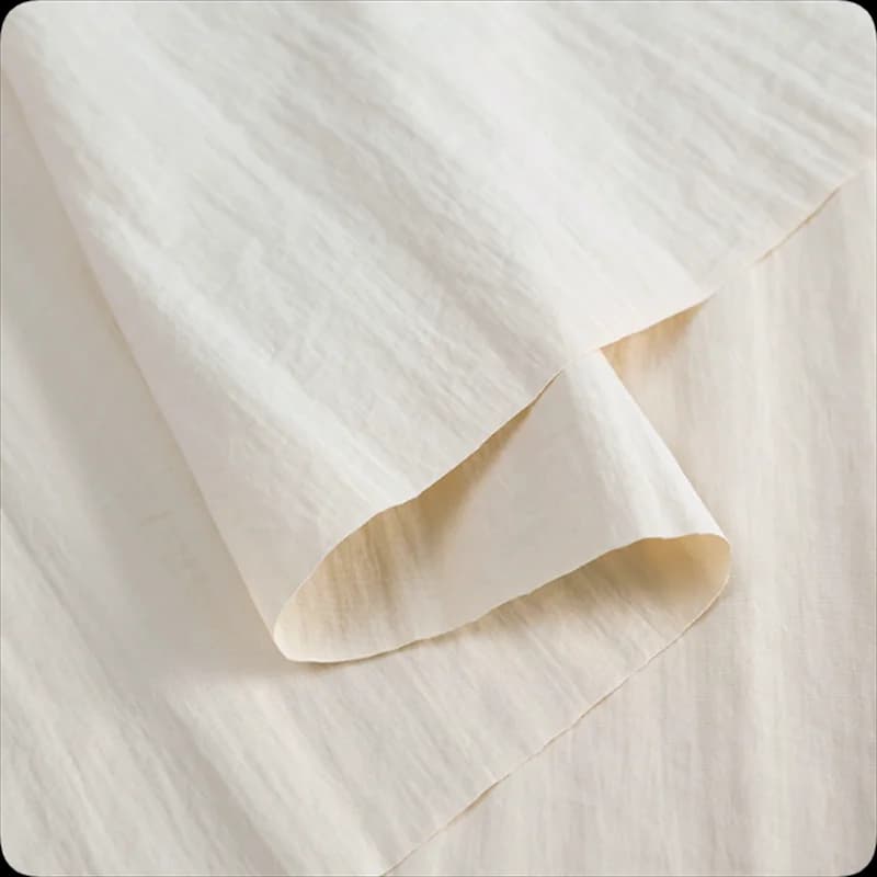 What is Cordura fabric? A light-coloured, textured Heavy Duty Cordura Fabric, folded and draped.