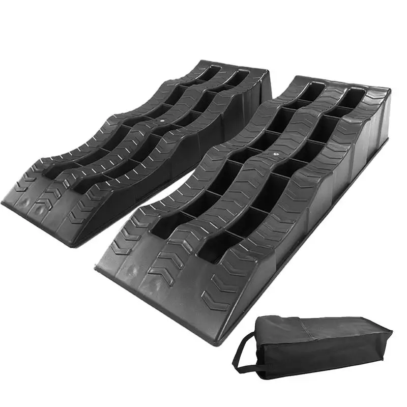 Two gray RV leveling ramps, serving as versatile wheel chocks for stabilizing campers on uneven terrain.