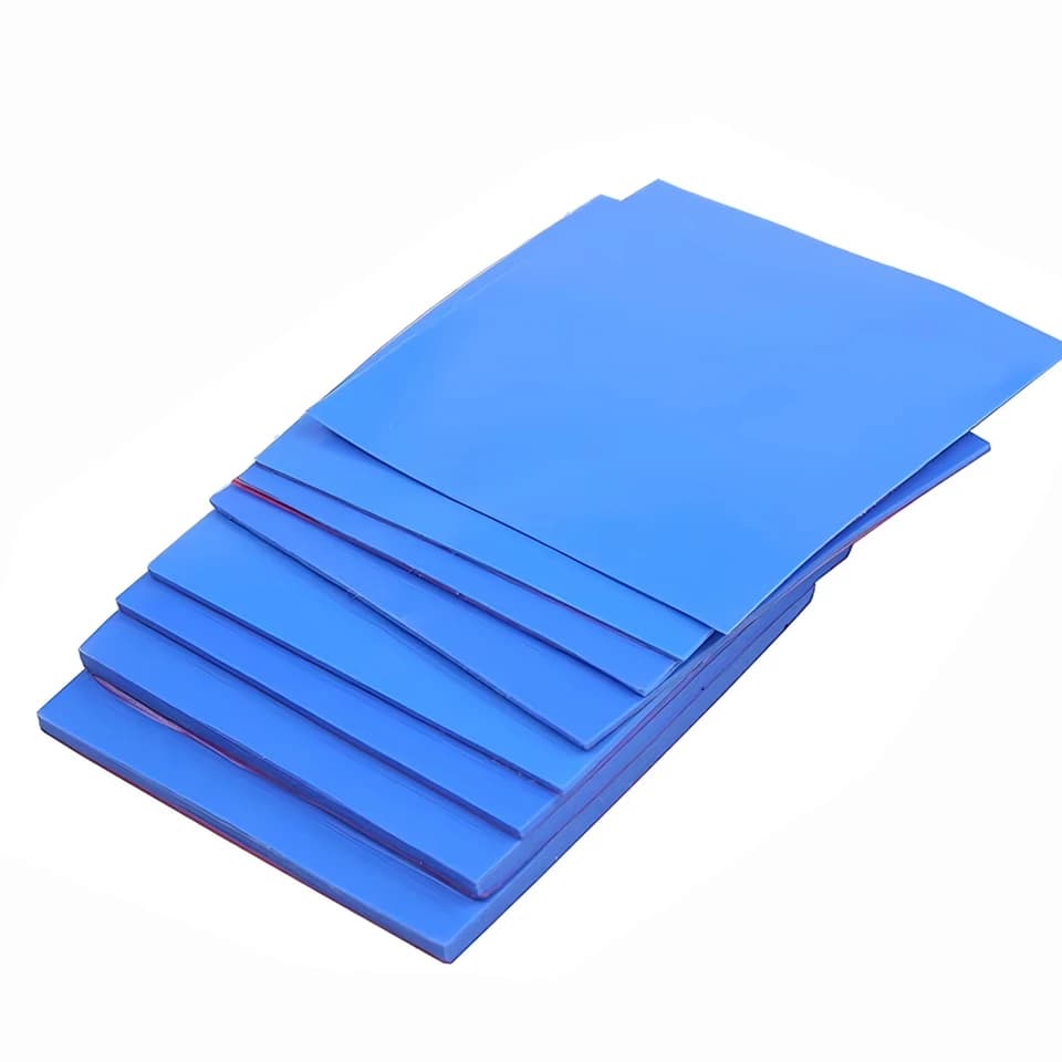 Thermal Base Layer Pads: Stack of blue rectangular sheets on white.