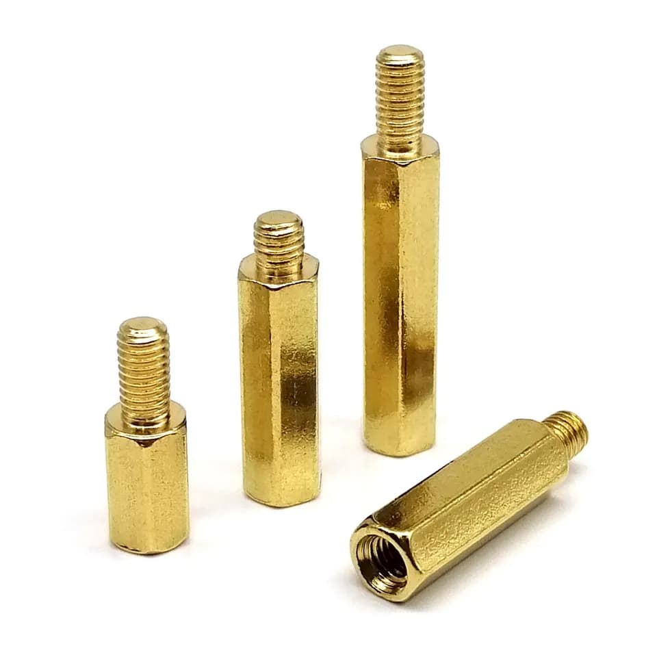 A collection of brass and copper hexagon pillar column male-female spacers, similar to wheel spacers, for PCB motherboards.