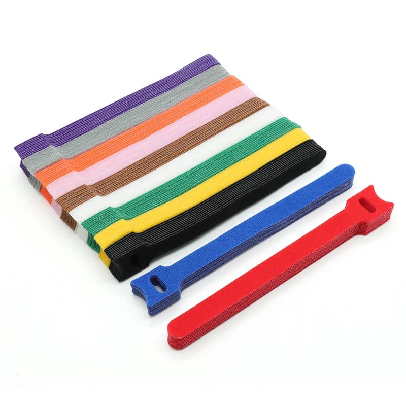 300mm Reusable Cable Ties: multiple colourful ties, stacked and laid out on white.