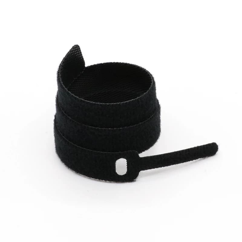 Wall Ties: Single black velcro strap on white background.