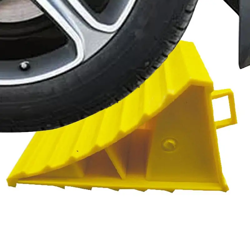 A black plastic wheel chock with a textured surface, designed to provide stable support for vehicle tires.