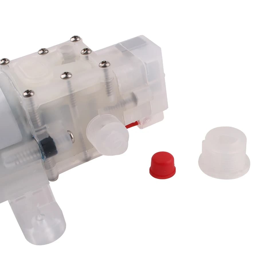 Condensate Pump 70/80W: transparent pump with small accessories on white.