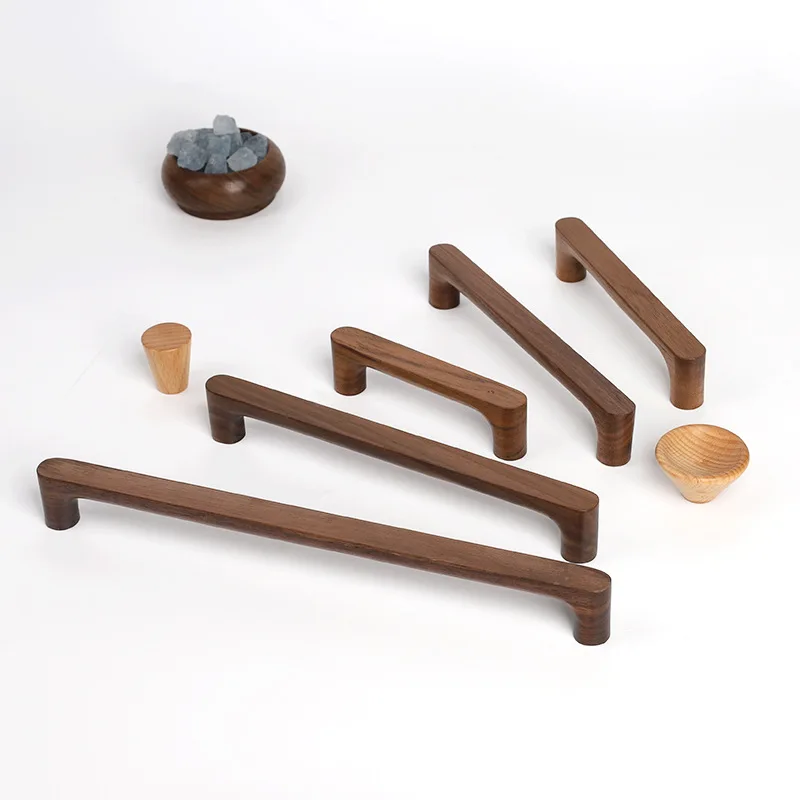 Nordic-style solid beech wood furniture handles and knobs for kitchen cabinets, wardrobes, and drawers with a natural wood grain finish.