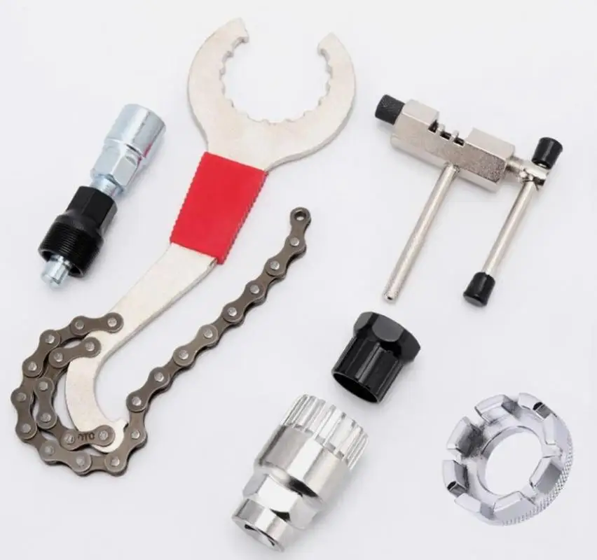 Professional bicycle repair tool kit with flywheel remover, chain breaker, crank puller, and spoke wrench for MTB and road bike maintenance.