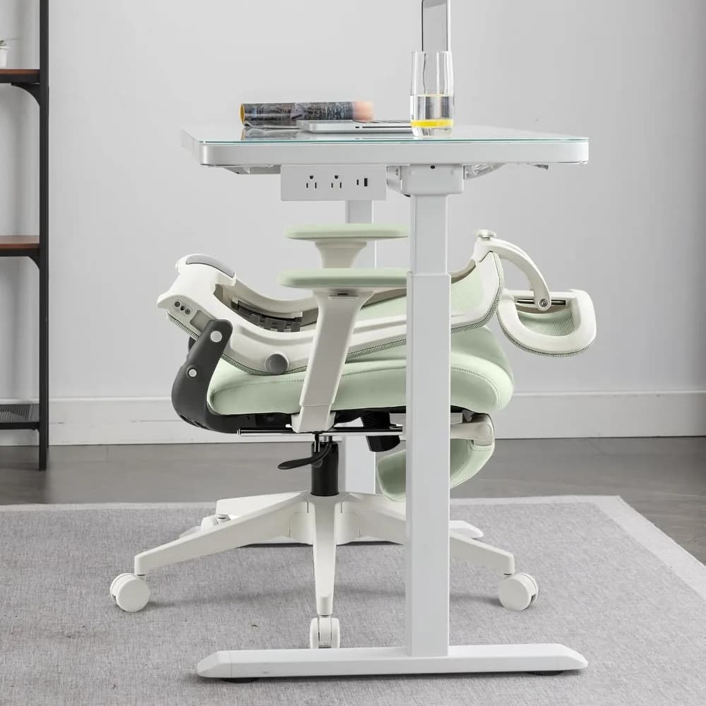 Green foldable ergonomic office chair with adjustable lumbar support, headrest, armrests, and built-in footrest for comfortable work sessions.
