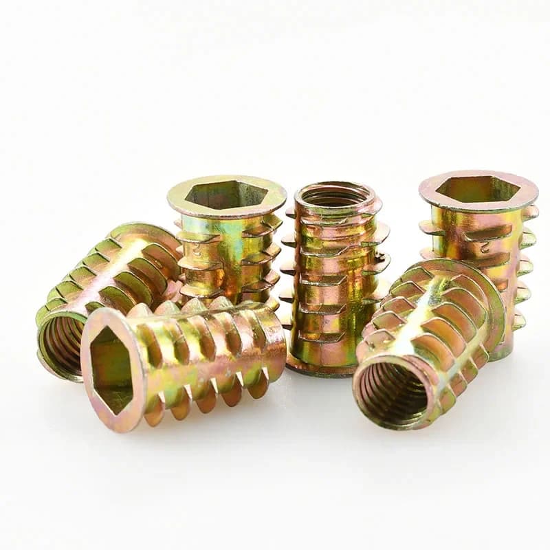 Assortment of zinc-plated carbon steel hex socket insert nuts for woodworking, sizes M4 through M10, used for creating strong threaded connections in furniture.
