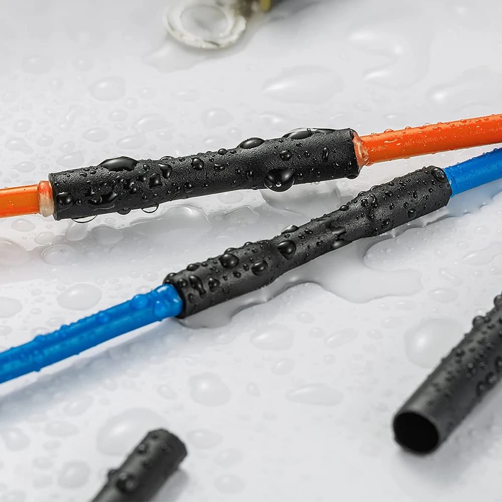 Black heat shrink tubing kit for electrical insulation, featuring thermoresistant sleeves to protect wire connections and cable splices.