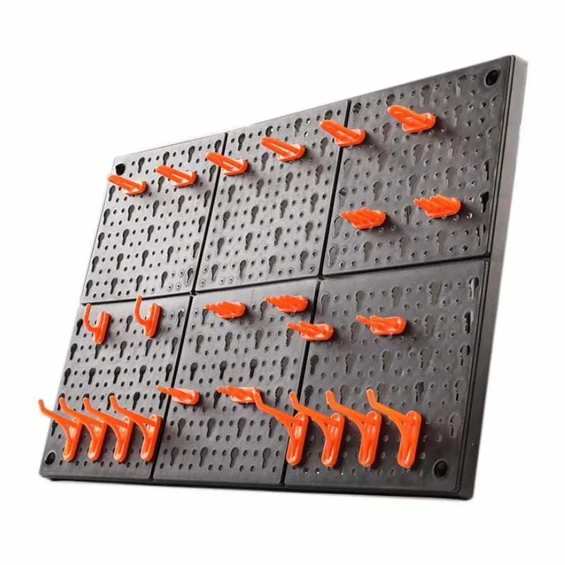 Wall-mounted tool hanging board with hooks and storage compartments for organizing hardware in a garage or workshop.