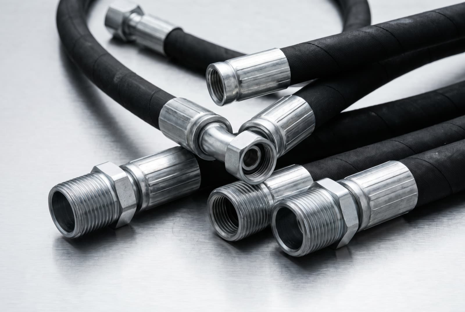 Hydraulic hoses with crimped end fittings