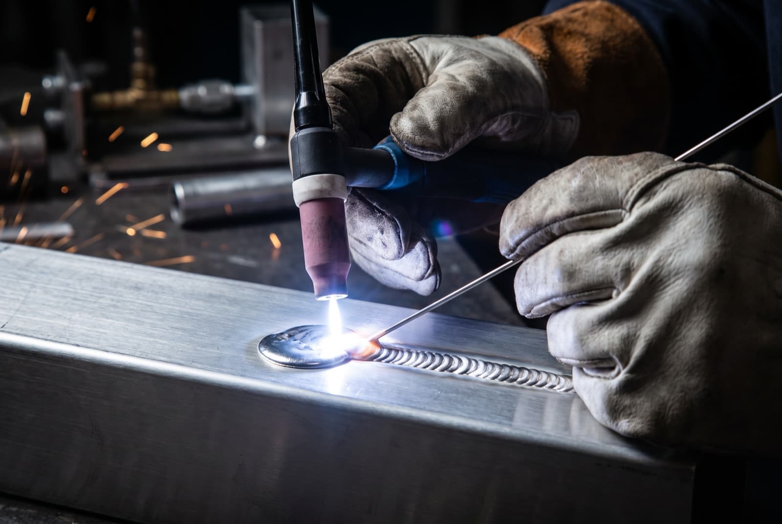 TIG welding an aluminium part with a torch and filler rod