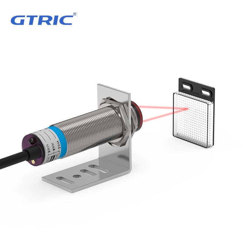 GTRIC M18 Series retro-reflective photoelectric sensor with visible spot, 10-30V NPN PNP, 8M adjustable sensing.