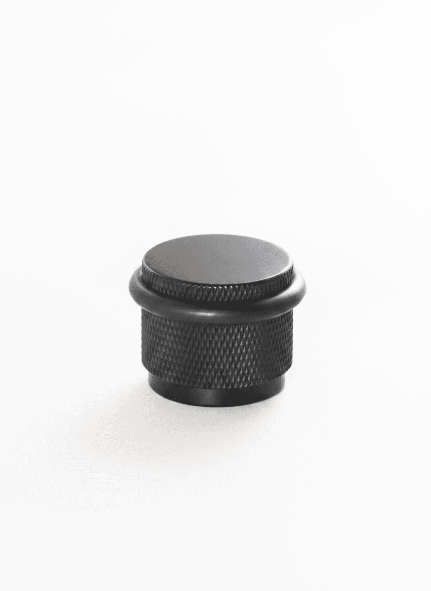Nurlin Brass Rubber Door Stopper, single unit on white background.