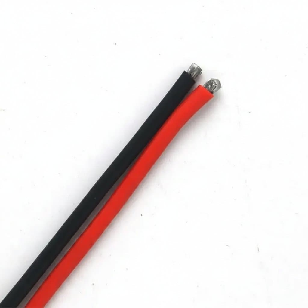 Tap flexible connector: stripped red and black electrical wires on white.